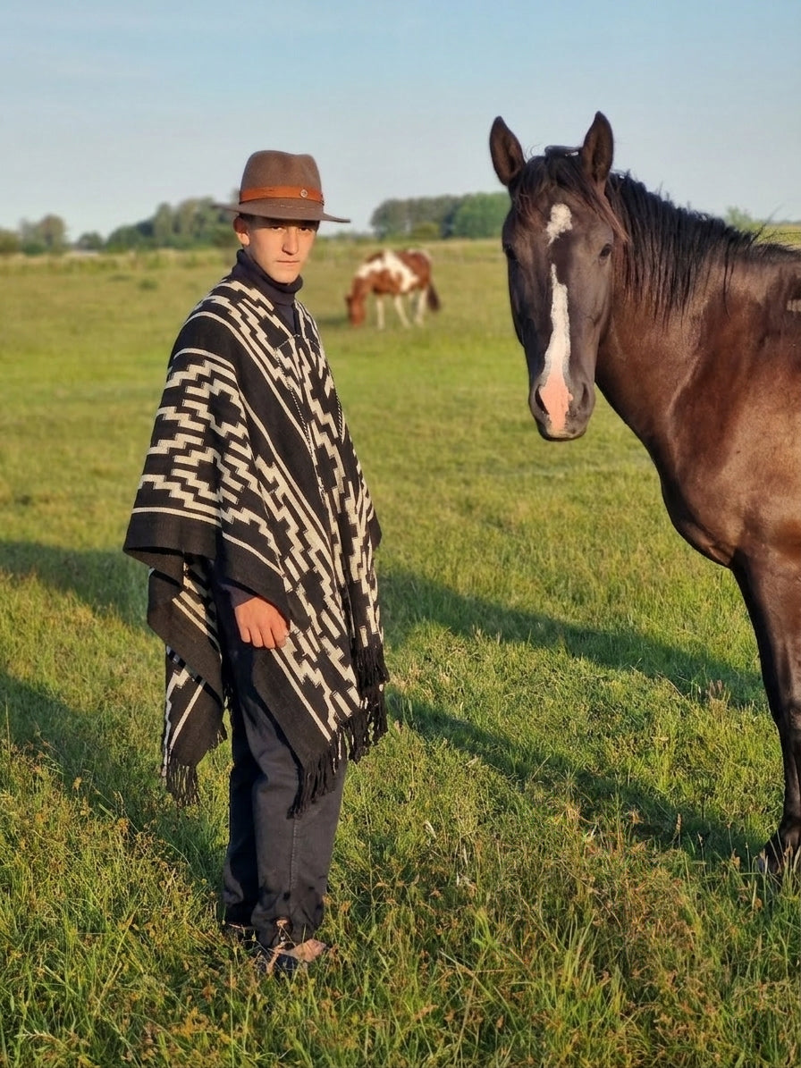Quijano handwoven wool poncho worn outdoors, showing its full drape